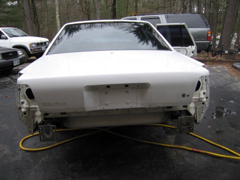 1991 Ford LTD Crown Victoria - Rear view of a white 1991 Ford Crown Victoria LTD, missing its rear bumper and taillights.