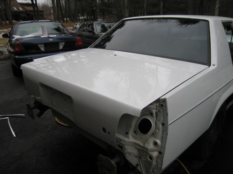 1991 Ford LTD Crown Victoria - Rear view of a white 1991 Ford Crown Victoria LTD undergoing work, with another similar vehicle behind it.