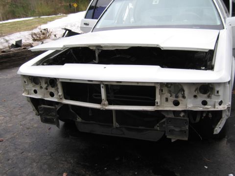 1991 Ford LTD Crown Victoria - Front view of a 1991 Ford Crown Victoria LTD undergoing disassembly, showing the engine bay and front structure.