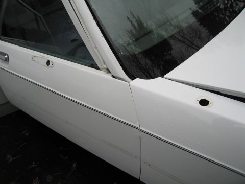 1991 Ford LTD Crown Victoria - Side view of a white 1991 Ford Crown Victoria LTD sedan, highlighting the door and fender panel alignment.