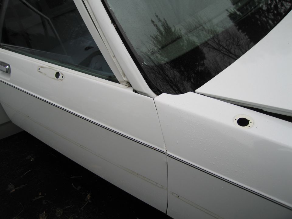 White 1991 Ford Crown Victoria LTD sedan, side view, showing door and fender seam, with a black pinstripe