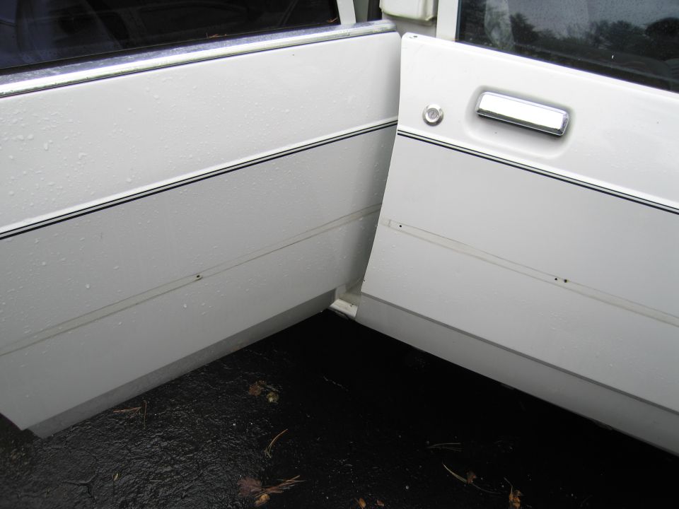 White car doors with chrome handles and black trim. 1991 Ford Crown Victoria LTD