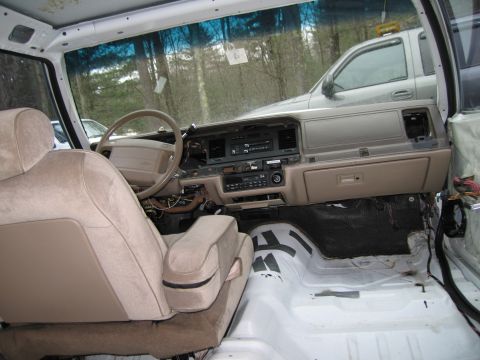 1991 Ford LTD Crown Victoria - Interior view of a disassembled car, revealing exposed wiring and a bare cabin floor.