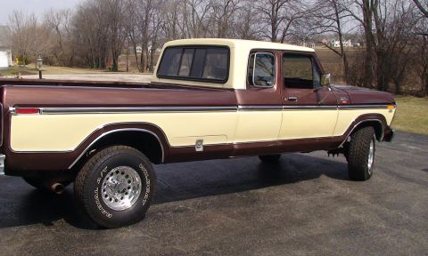 1979 Ford Bronco - This pickup truck features a crew cab and a long bed, with chrome wheels and trim.