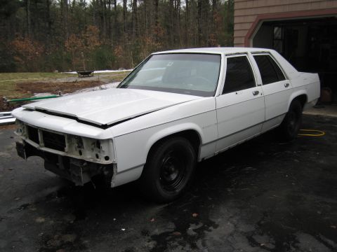 1991 Ford LTD Crown Victoria - This 1991 Ford Crown Victoria LTD is seen from a 3/4 front angle, showing damage to its front end.