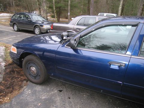1991 Ford LTD Crown Victoria - A blue sedan is parked in a driveway with other vehicles visible.