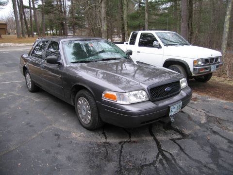 1991 Ford LTD Crown Victoria - This 1991 Ford Crown Victoria LTD is seen in a 3/4 front view, parked alongside a white pickup truck.