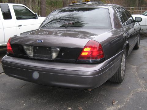 1991 Ford LTD Crown Victoria - This Ford Crown Victoria, likely from the early 2000s, is parked outdoors next to a pickup truck.