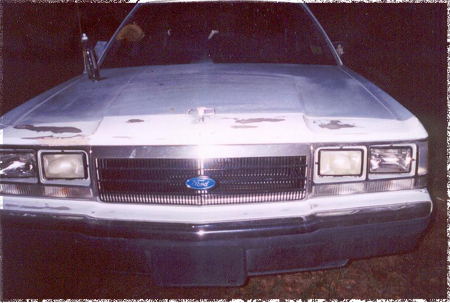 1991 Ford Crown Victoria - Front view of a 1991 Ford Crown Victoria, highlighting its grille and headlight design.