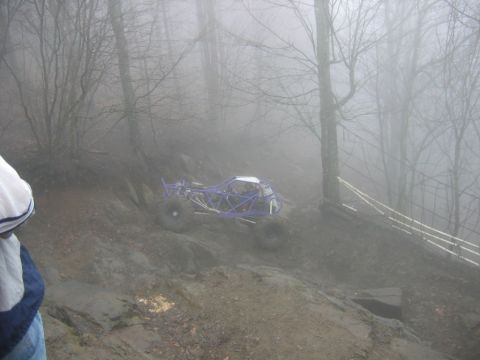 1992 Ford Mustang - A custom-built buggy navigates a challenging, wet terrain on a foggy day.