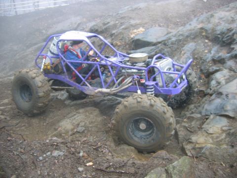 1992 Ford Mustang - This custom buggy navigates a challenging rocky and muddy terrain during an off-road event.