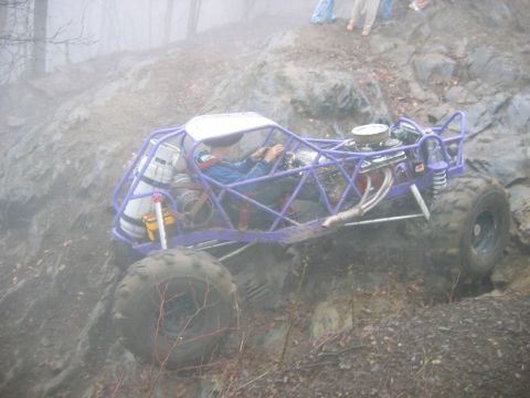 1992 Ford Mustang - A custom-built purple buggy navigates a challenging rocky terrain, demonstrating its off-road capabilities.