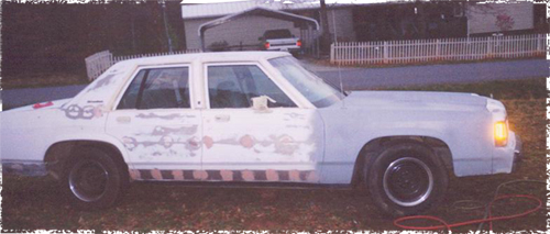1991 Ford Crown Victoria with body filler on doors and fender, undergoing repair