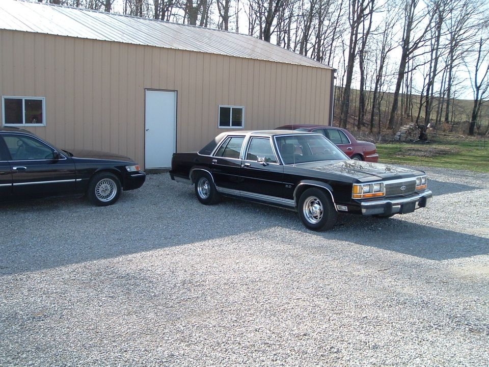 Black 1999 Mercury Grand Marquis 3/4 front view parked outside