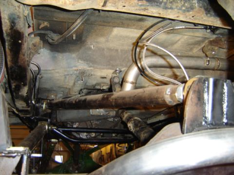 1992 Ford Bronco - Custom exhaust system installed on vehicle undercarriage, showing suspension and frame details.
