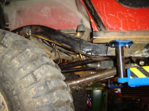 1992 Ford Bronco - Undercarriage view of a modified off-road vehicle, highlighting its robust frame and suspension system.