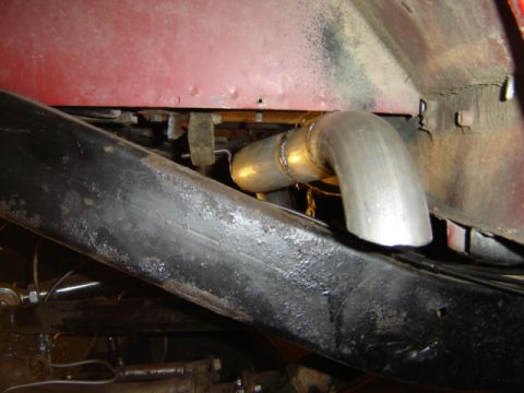 1992 Ford Bronco - Close-up view of an exhaust pipe installation on a vehicle's undercarriage.