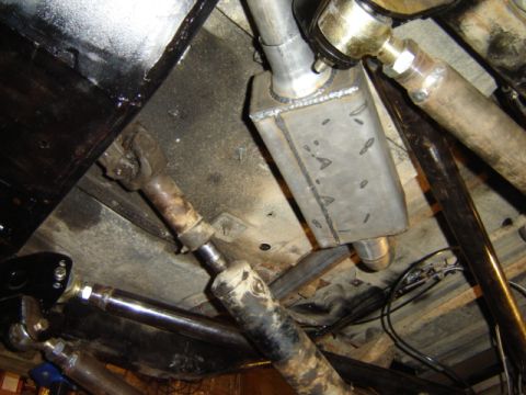 1992 Ford Bronco - Custom exhaust system and driveshaft components visible from the undercarriage of a vehicle.