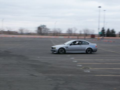 2001 Mercury Grand Marquis - A silver coupe with racing numbers is seen on a track during an event.