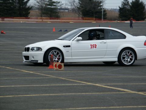 2001 Mercury Grand Marquis - A white BMW M3 coupe is seen on a race track, marked with the number 352.