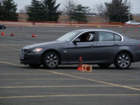 2001 Mercury Grand Marquis - A dark gray sedan is driven on a track with cones, likely during a performance driving event.
