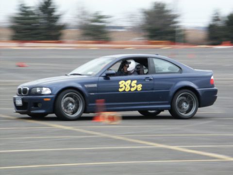 2001 Mercury Grand Marquis - A blue coupe with racing numbers on the door navigates a track, with orange cones visible.