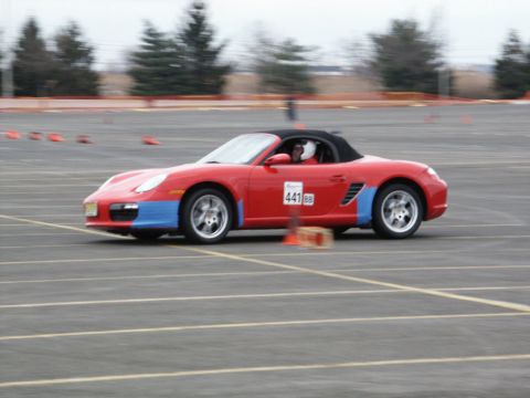 2001 Mercury Grand Marquis - A red convertible sports car with blue accents on its fenders navigates a race track, displaying the number 441.