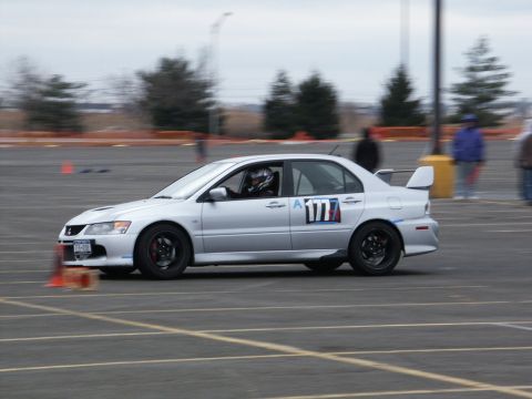 2001 Mercury Grand Marquis - A silver sedan with racing decals navigates a course marked by orange cones.