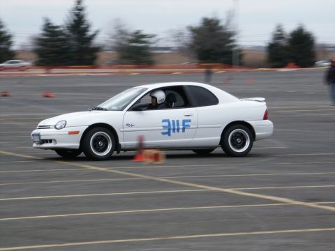 2001 Mercury Grand Marquis - White coupe with blue racing numbers on the door navigates a course marked by cones.
