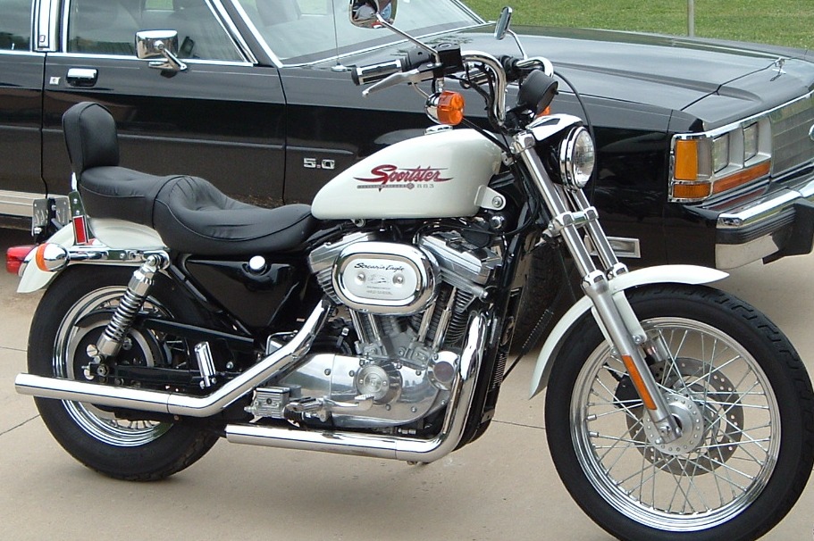 White Harley-Davidson Sportster 883, right side view with Screamin' Eagle air cleaner and chrome exhaust