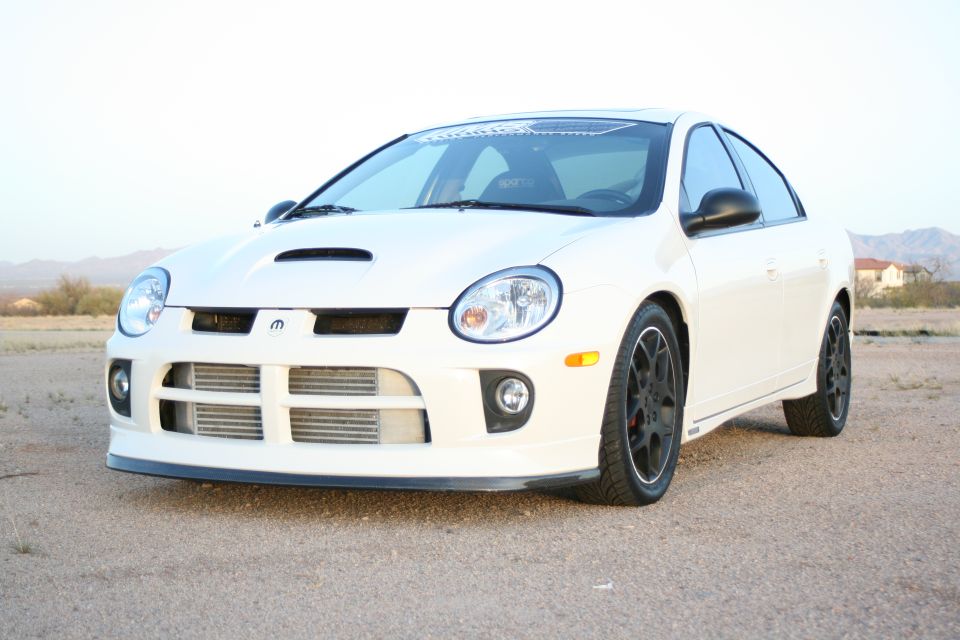 White Dodge Neon SRT-4 with a hood scoop and intercooler visible