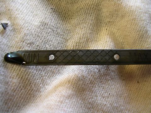 2007 Mazda 3 - The oil level on the dipstick is between the minimum and maximum indicators.