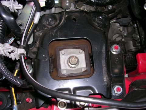 2007 Mazda 3 - Close-up of a vehicle's engine mount bracket and isolator assembly.