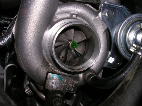 2007 Mazda 3 - A turbocharger part with a visible serial number tag is shown in detail.