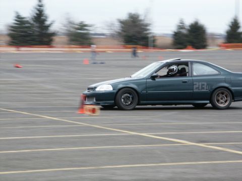2001 Mercury Grand Marquis - A dark green coupe navigates a race course with orange cones visible.