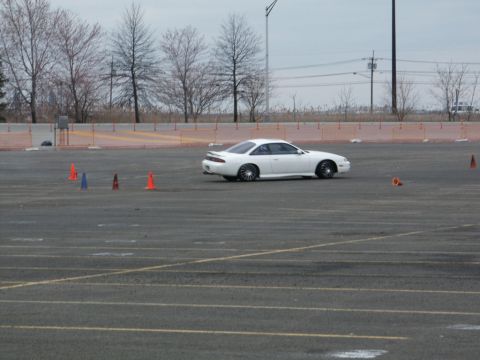 2001 Mercury Grand Marquis - A white coupe navigates a course marked by traffic cones on a paved track.