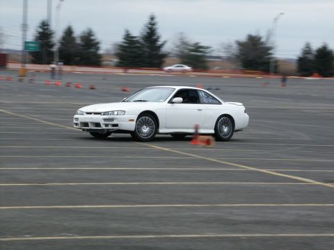 2001 Mercury Grand Marquis - White Nissan 240SX coupe navigates a course marked by cones.