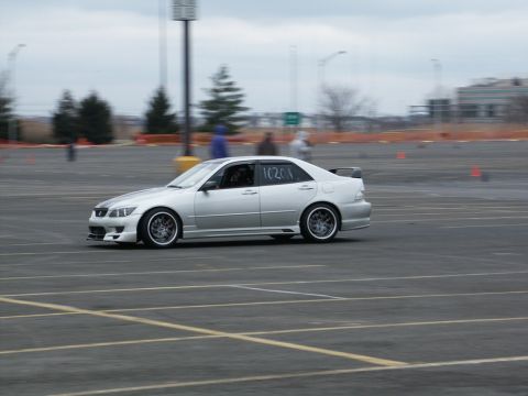 2001 Mercury Grand Marquis - A silver Lexus IS300 is seen on a race track with orange cones marking the course.