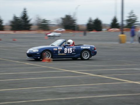 2001 Mercury Grand Marquis - A blue Mazda convertible with racing decals navigates a course marked by orange cones.