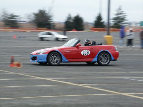 2001 Mercury Grand Marquis - Convertible sports car with racing number 353 navigates a track, with another vehicle blurred in the background.