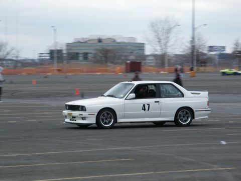 2001 Mercury Grand Marquis - A white BMW E30 M3 with racing number 47 is seen on a track during an event.