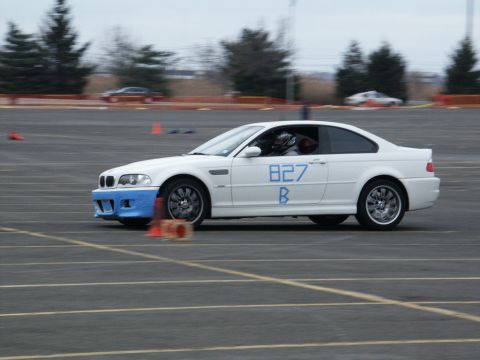 2001 Mercury Grand Marquis - A white coupe with a blue front bumper and blue racing numbers is seen on a track.