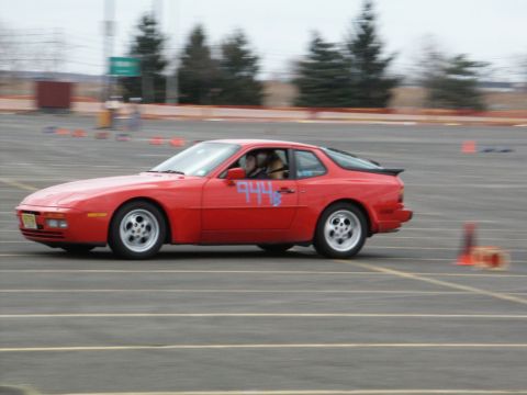 2001 Mercury Grand Marquis - Red Porsche 944 coupe seen on a race track during an event.
