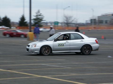 2001 Mercury Grand Marquis - A silver Subaru WRX sedan is seen on a race track, with the number 223 displayed on its side.