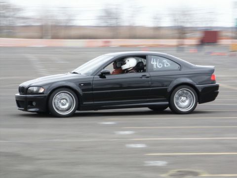 2001 Mercury Grand Marquis - Black BMW M3 coupe with racing number 46B on the door is seen on a track.
