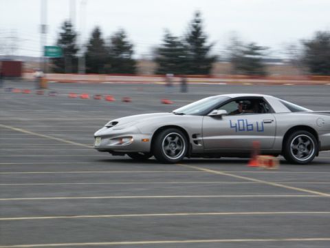 2001 Mercury Grand Marquis - A silver Pontiac Firebird is seen on a race track, marked with '406U' on its side.