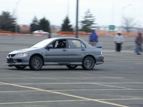 2001 Mercury Grand Marquis - A gray Mitsubishi Lancer Evolution is captured in motion on a paved surface, possibly during a track event.