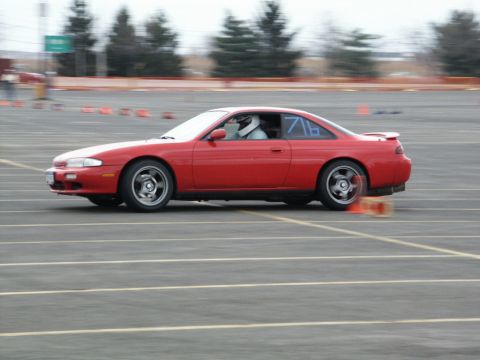 2001 Mercury Grand Marquis - A red coupe navigates a race track, indicated by orange cones and racing numbers on the window.