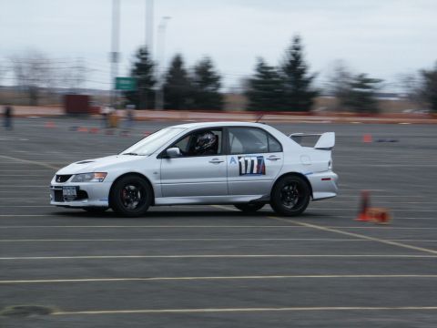 2001 Mercury Grand Marquis - A silver Mitsubishi Lancer Evolution VII competes on a race track, displaying the number 177.