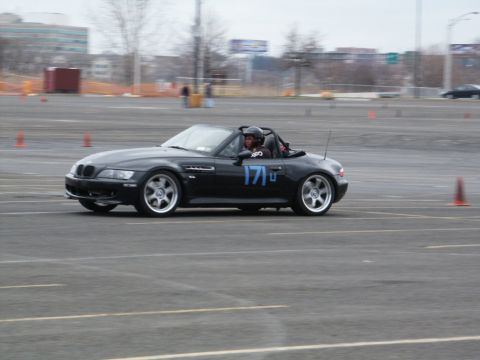2001 Mercury Grand Marquis - A black convertible sports car, identified by racing number 171, navigates a course on a paved lot.